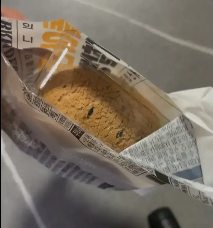 Tearing open the packaging of the Custard Sesame Bread