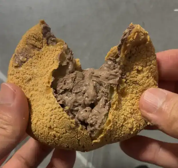 Close-up of the gooey chocolate filling inside the sesame bread