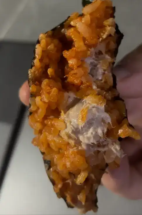 A close-up of the final bite of the chili tuna kimbap