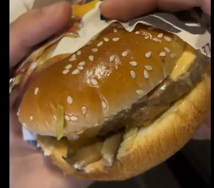 A close-up of the burger right before taking a bite