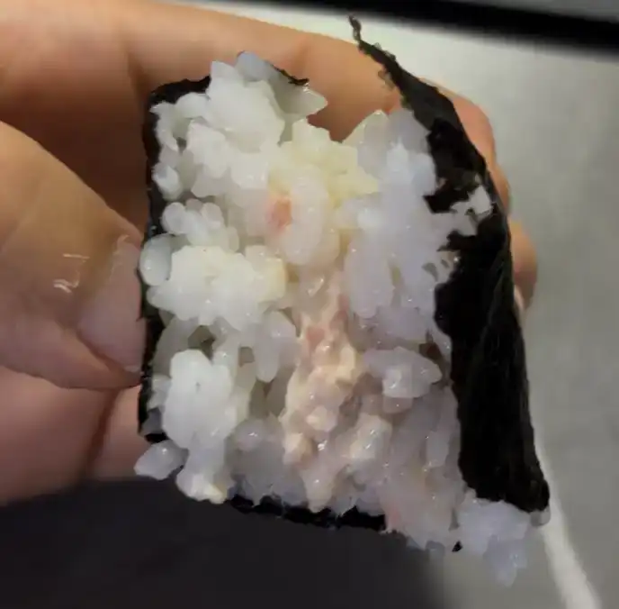 A single broken piece of the GS25 Light Tuna Mayo Triangle Kimbap
