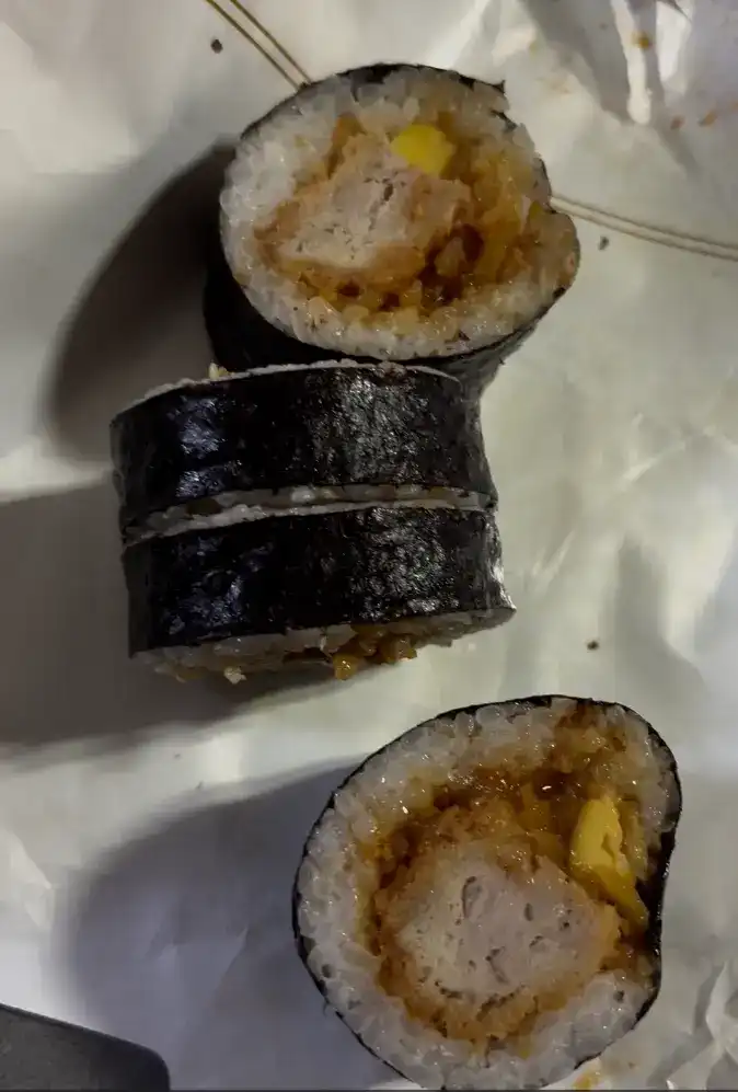 Detailed view of the pork cutlet, egg, and radish filling