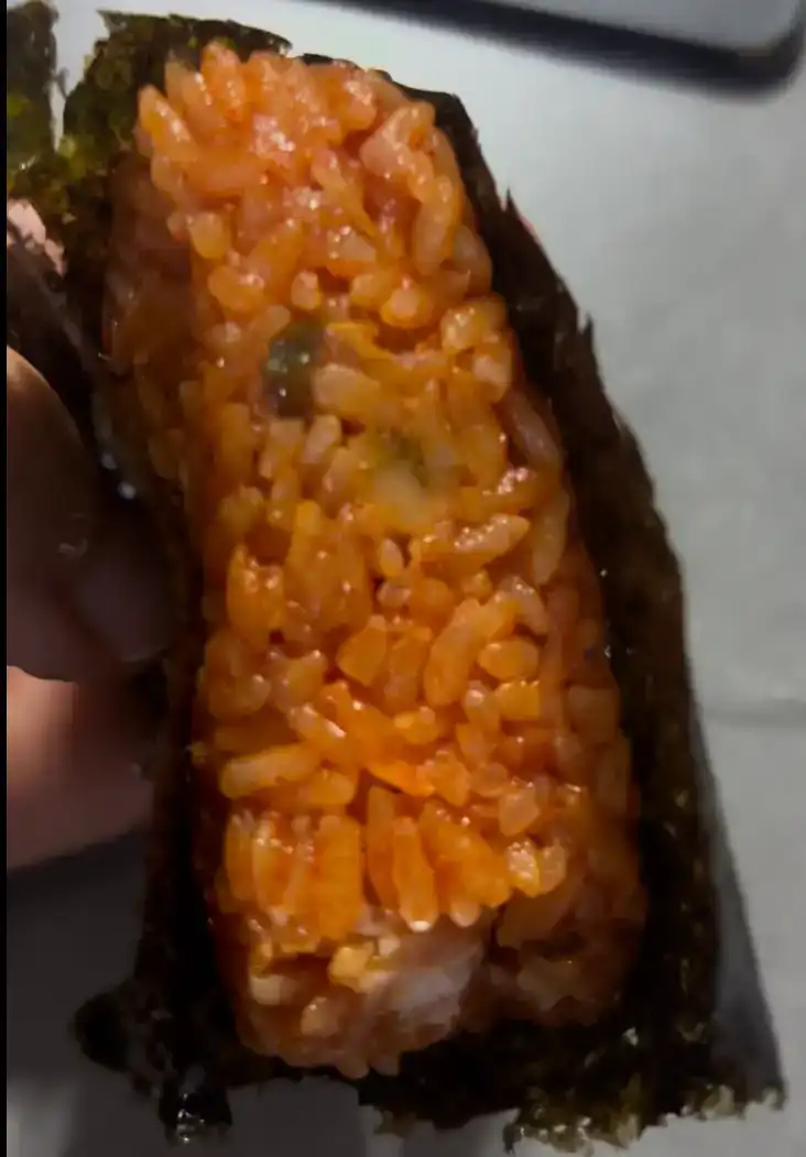 Close-up of the seasoned rice grains of the GS25 Spam Kimchi Fried Rice Triangle Kimbap
