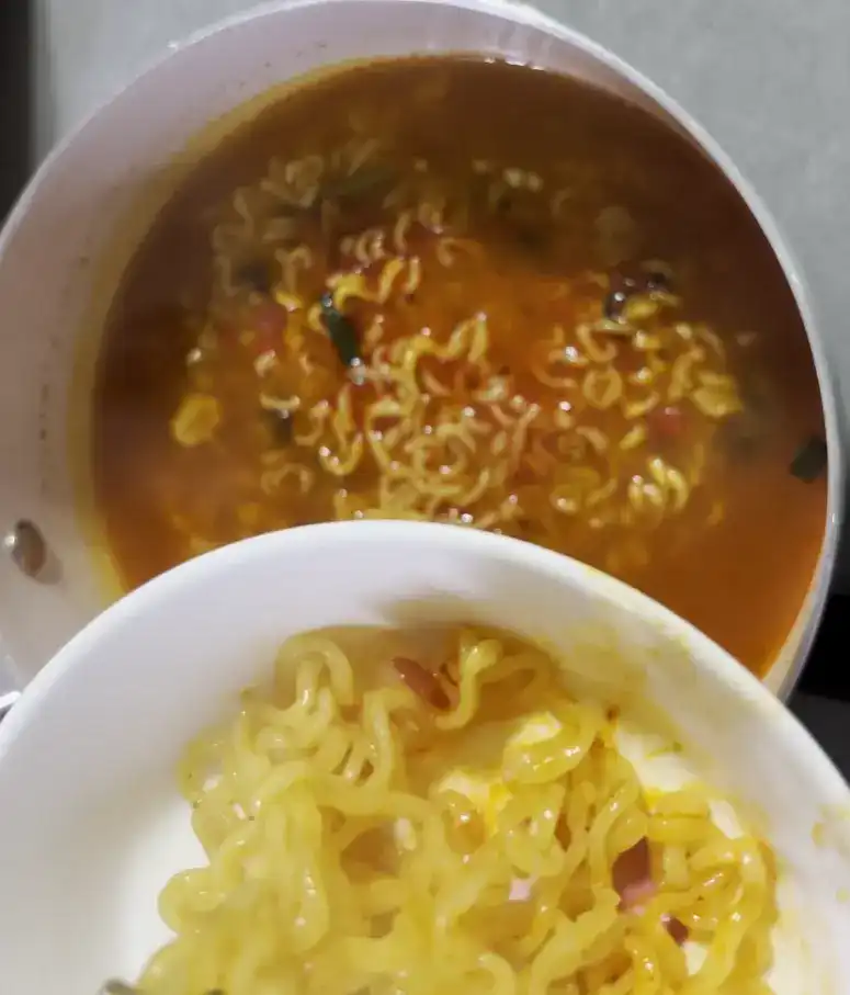 Eating the delicious Shin Ramyun Gold with chopsticks