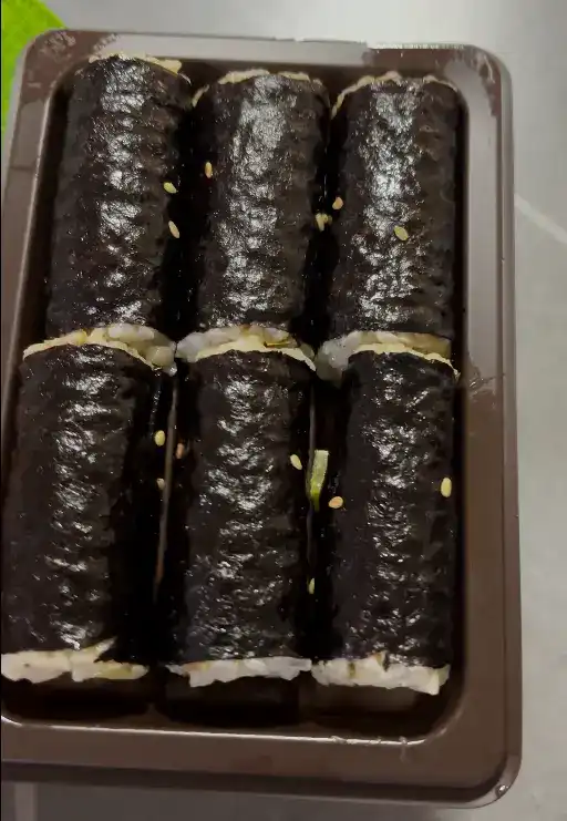 Tearing open the packaging of the mini gimbap