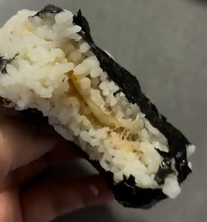 Inside look of the GS25 Perilla Oil Muted Kimchi Tuna Triangle Kimbap showing the filling