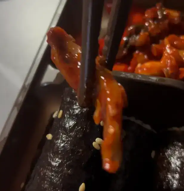 A close-up of the spicy seasoned squid and radish salad