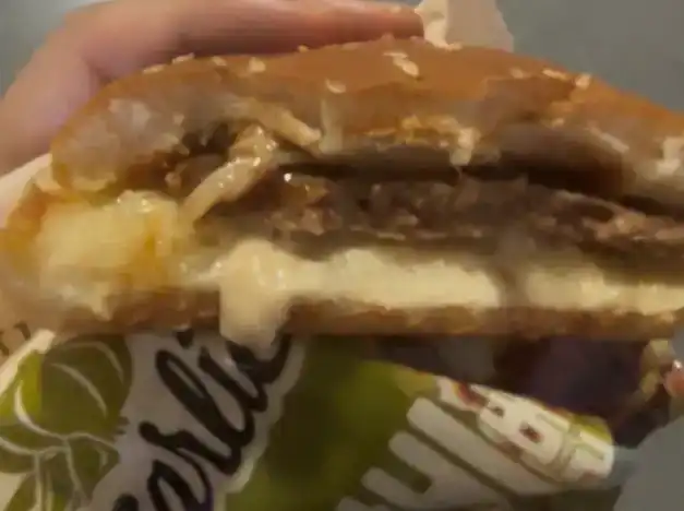 A half-eaten piece of the GS25 Garlic Galbi Burger