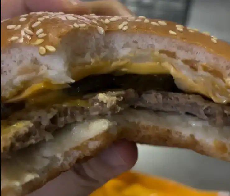 Inside look of the GS25 2300 KRW Good Deal Cheeseburger showing the melted cheese and patty