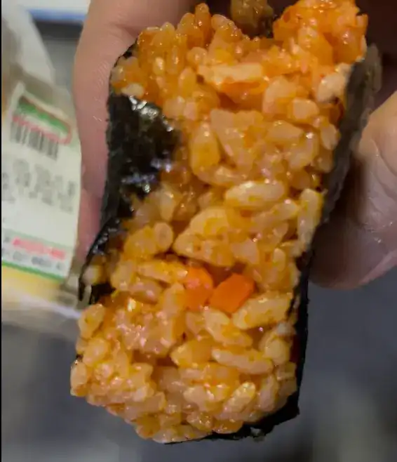 A close-up of a bite of the Bulgogi Jeonju Bibim Samgak Kimbap