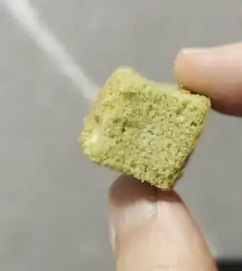 A single bite-sized piece of the GS25 Matcha Rusk