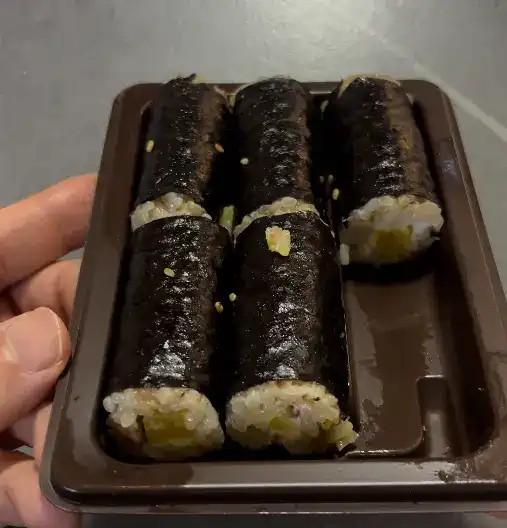 Taking a bite of the mini gimbap