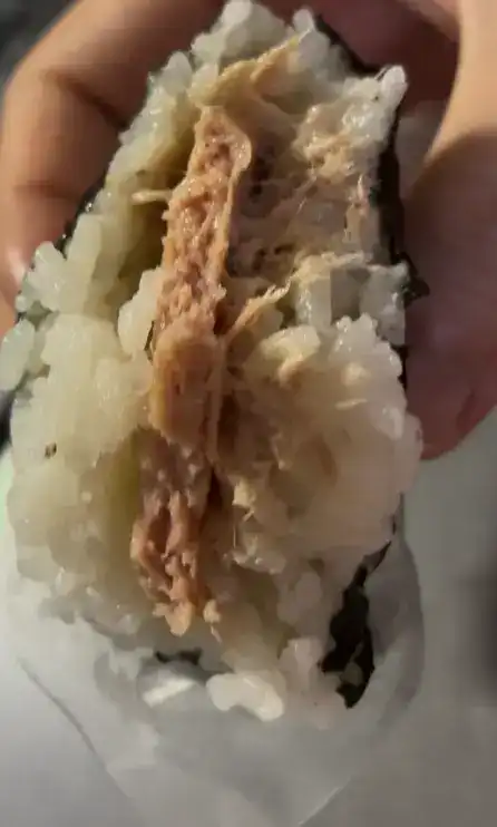 The remaining half piece of the Richam Tuna Mayo triangle gimbap