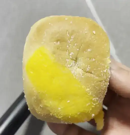 A torn piece of the GS25 Mango Soft Bun