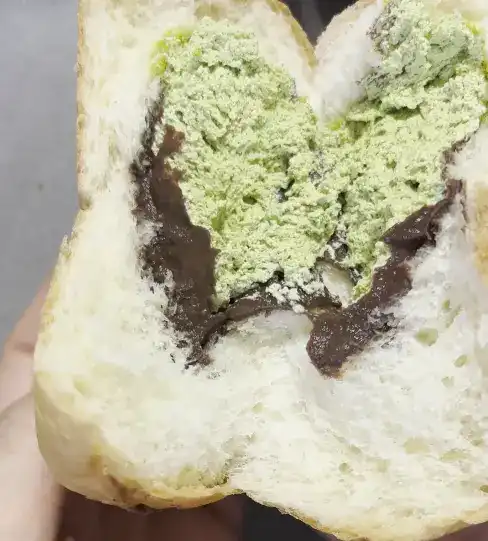 Cross-section showing the generous amount of cream inside the split bread
