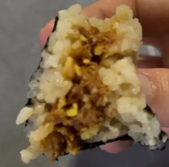 A close-up of the beef and egg filling after a bite