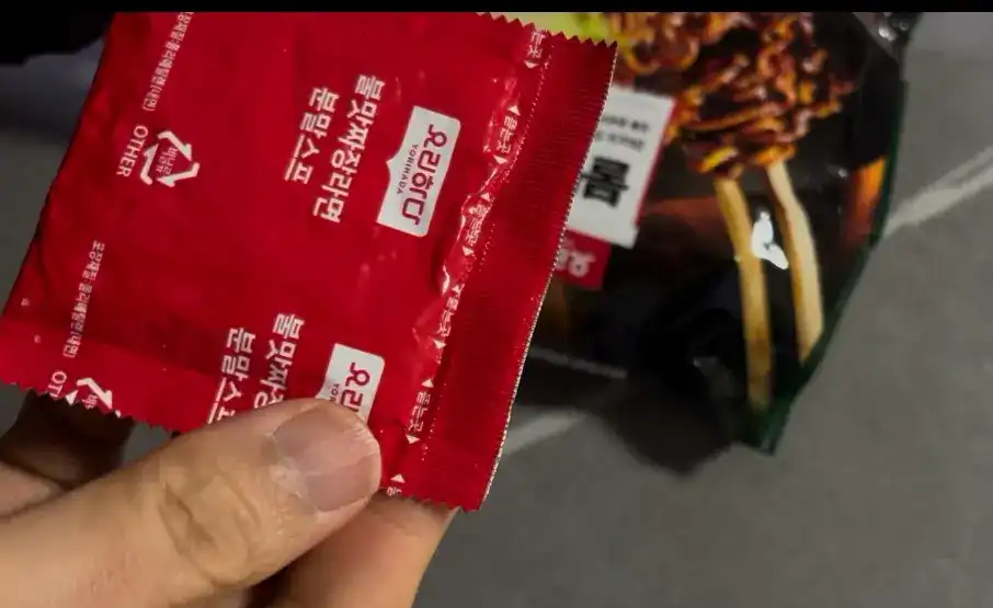 A close-up of the sauce powder packet inside the ramen