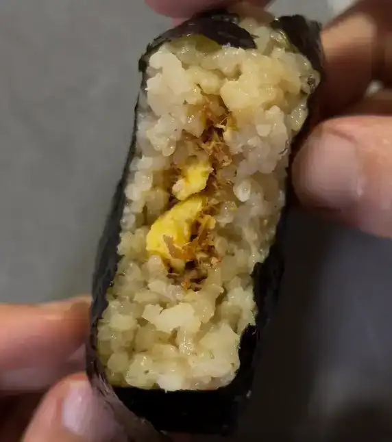 The inside filling of the Samgak Kimbap showing beef and egg