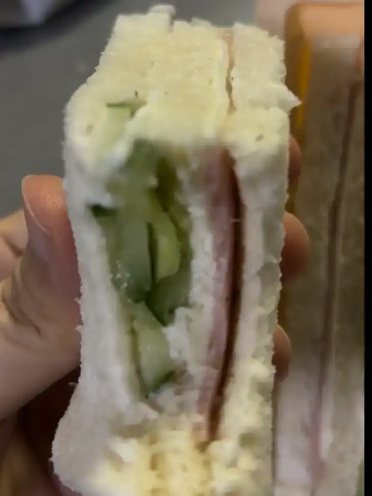 A half-eaten piece of the delicious GS25 Ham Cucumber Cream Cheese Sandwich