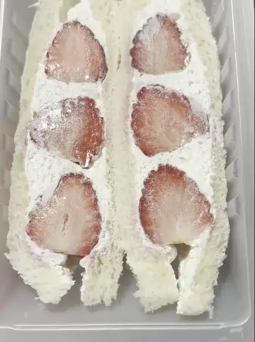 Close-up of dry glass noodles, dried vegetable flakes, and liquid sauce packets inside the Ottogi Japchae package