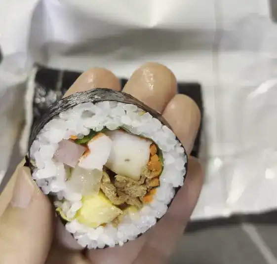 A close-up of a single slice of CU Basic Gimbap
