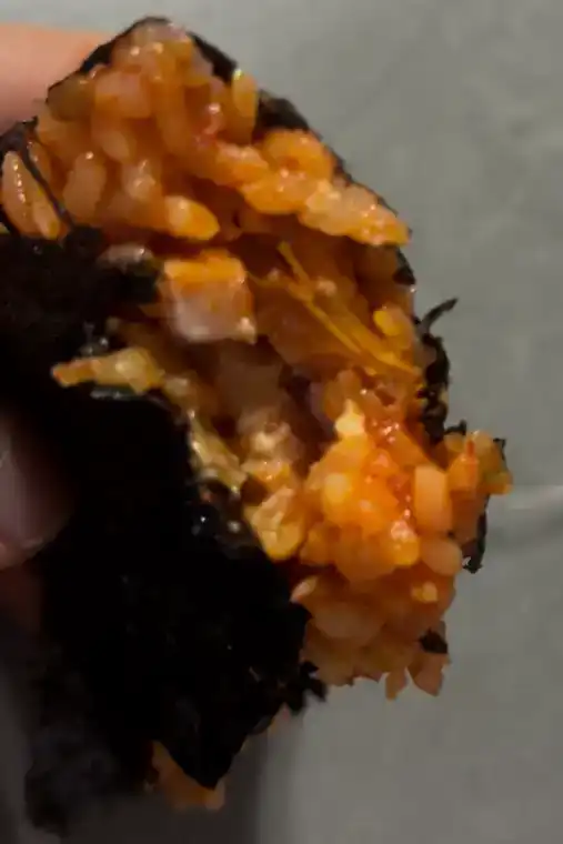Inside look of the GS25 Spam Kimchi Fried Rice Triangle Kimbap showing the diced Spam fillings