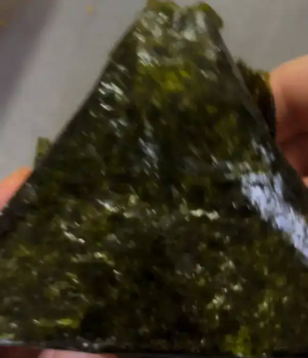The unwrapped big samgak kimbap showing the large portion of white rice
