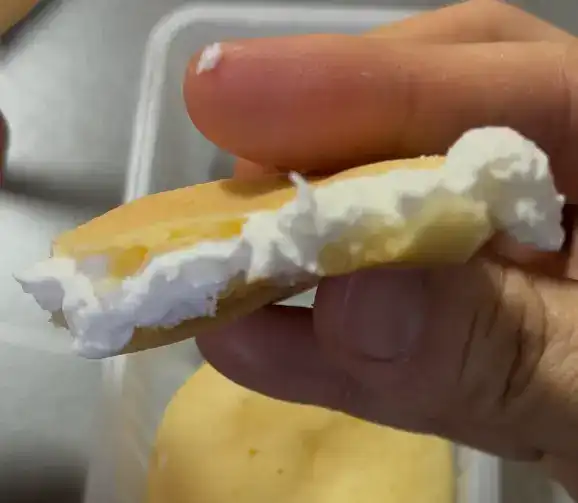 A close-up showing the rich milk cream filling inside the mochi ball