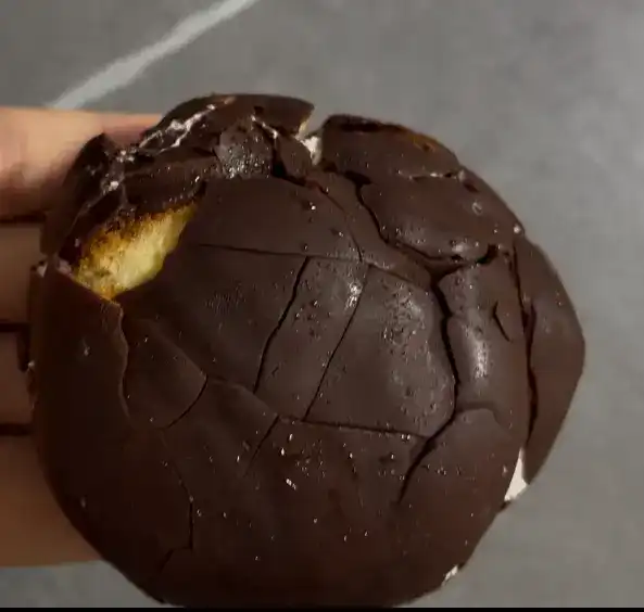 The unwrapped chocolate pie showing its glossy coating